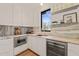 Modern kitchen with white cabinets, stainless steel appliances, and stylish marble countertops at 838 Woodburn Rd, Raleigh, NC 27605