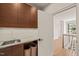 Well-equipped laundry room with elegant countertops and storage solutions for organization at 838 Woodburn Rd, Raleigh, NC 27605