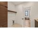 Well-lit laundry room with modern cabinetry, shelving, and a convenient layout at 838 Woodburn Rd, Raleigh, NC 27605