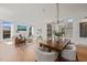 Spacious living and dining area with light wood floors and bright white walls at 838 Woodburn Rd, Raleigh, NC 27605