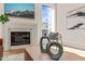 Bright living room with a fireplace, mountain art, decor, and a chair by a window at 838 Woodburn Rd, Raleigh, NC 27605