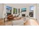 Bright living room with large windows, a fireplace, and modern furniture at 838 Woodburn Rd, Raleigh, NC 27605