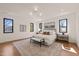 Bright main bedroom with many windows, stylish decor, and hardwood floors at 838 Woodburn Rd, Raleigh, NC 27605