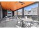 Covered patio with a beautiful fireplace, seating, and an outdoor dining table at 838 Woodburn Rd, Raleigh, NC 27605