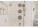 Beautiful marble shower featuring premium fixtures, a built-in niche, and sleek design at 838 Woodburn Rd, Raleigh, NC 27605