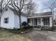 Charming white cottage-style home with a covered porch and maroon shutters at 901 W Anderson St, Selma, NC 27576