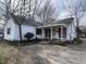 Charming white cottage-style home with a covered porch and maroon shutters at 901 W Anderson St, Selma, NC 27576