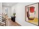 Entryway with modern art, wood floors, and a staircase leading to upper levels at 917 Montague Ave, Durham, NC 27703