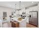 Bright kitchen features stainless steel appliances, white cabinetry, and a spacious center island at 917 Montague Ave, Durham, NC 27703