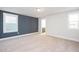 Bright bedroom features two windows, plush carpet and neutral paint at 928 Allen Park Dr, Knightdale, NC 27604
