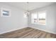 Bright dining room with wood floor, modern lighting, and large windows showcasing neighborhood views at 928 Allen Park Dr, Knightdale, NC 27604