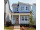 Charming two-story home featuring light blue siding, a welcoming front porch, and manicured landscaping at 928 Allen Park Dr, Knightdale, NC 27604