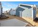 Row of newly constructed townhomes featuring light blue siding, white trim, and individual back patios with privacy fences at 928 Allen Park Dr, Knightdale, NC 27604