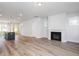 Open-concept living room boasts wood floors, fireplace and yellow front door at 928 Allen Park Dr, Knightdale, NC 27604