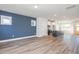 Open-concept living room with kitchen island, stainless appliances and yellow door at 928 Allen Park Dr, Knightdale, NC 27604