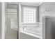 Bathroom featuring a jetted tub, walk-in shower, and glass block window at 100 Burlingame Way, Cary, NC 27513
