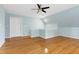A bonus room featuring vaulted ceiling, a ceiling fan and a light blue accent wall at 100 Burlingame Way, Cary, NC 27513