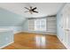 Bonus room with vaulted ceiling, built-in bookshelves, and a light blue accent wall at 100 Burlingame Way, Cary, NC 27513