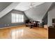 Upper room with wood flooring, a window and a seating area under a ceiling fan at 100 Burlingame Way, Cary, NC 27513