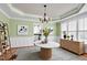 Charming dining room with decorative chandelier, wainscoting, and views to the kitchen at 100 Burlingame Way, Cary, NC 27513