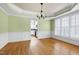 Dining room with hardwood floors looking into the adjacent kitchen at 100 Burlingame Way, Cary, NC 27513