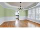 Charming dining room features large windows, wainscoting, and a view of the modern kitchen at 100 Burlingame Way, Cary, NC 27513