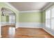 Airy dining room showcasing chair rail molding, large shuttered windows, and hardwood floors at 100 Burlingame Way, Cary, NC 27513
