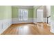 Spacious dining room featuring hardwood floors, chair railing, and ample natural light at 100 Burlingame Way, Cary, NC 27513