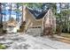 Charming home featuring a stone chimney and a two-car garage with extended driveway at 100 Burlingame Way, Cary, NC 27513