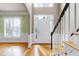 Well-lit foyer with hardwood floors, staircase, and direct access to the living spaces at 100 Burlingame Way, Cary, NC 27513