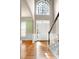 Foyer area showcasing a front door with transom window and staircase at 100 Burlingame Way, Cary, NC 27513