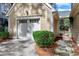 Detached garage featuring white door, lamp, manicured bushes, and stone pathway at 100 Burlingame Way, Cary, NC 27513
