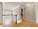 Bright second story hallway featuring hardwood floors, wainscotting, decorative window, and recessed lighting at 100 Burlingame Way, Cary, NC 27513