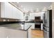 Bright kitchen featuring granite countertops, stainless steel appliances, and ample cabinet space at 100 Burlingame Way, Cary, NC 27513