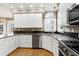 Modern kitchen featuring white cabinets, granite countertops, and stainless steel appliances at 100 Burlingame Way, Cary, NC 27513