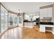 Open concept kitchen and eat-in area with hardwood floors, granite countertops, and stainless steel appliances at 100 Burlingame Way, Cary, NC 27513