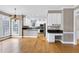 Open concept kitchen and eat-in area with hardwood floors, granite countertops, and stainless steel appliances at 100 Burlingame Way, Cary, NC 27513