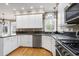 Modern kitchen showcases granite countertops, stainless appliances, stylish backsplash, and ample cabinet space at 100 Burlingame Way, Cary, NC 27513
