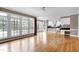 Bright living room boasts hardwood floors, large windows, and seamless flow to the kitchen and dining areas at 100 Burlingame Way, Cary, NC 27513