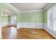 Bright, sunny living room boasts hardwood floors and classic wainscoting at 100 Burlingame Way, Cary, NC 27513