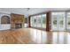 Bright living room with stone fireplace, built-in shelving, and access to the backyard at 100 Burlingame Way, Cary, NC 27513