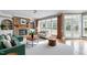 Bright living room with stone fireplace, built-in shelves, large windows, and hardwood floors at 100 Burlingame Way, Cary, NC 27513