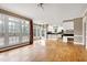 Open-concept living room with hardwood floors connects to a modern kitchen at 100 Burlingame Way, Cary, NC 27513