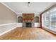 Spacious living room with stone fireplace, built-in shelves, hardwood floors and plenty of natural light at 100 Burlingame Way, Cary, NC 27513