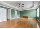 An expansive main bedroom with a tray ceiling, recessed lighting and gleaming hardwood floors at 100 Burlingame Way, Cary, NC 27513
