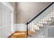 Beautiful staircase featuring wood treads, white risers, a black handrail, and natural light at 100 Burlingame Way, Cary, NC 27513