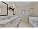 Bright bathroom with double vanity, bathtub, and glass-enclosed shower at 101 Overlake Dr, Chapel Hill, NC 27516