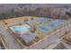 Aerial view of community amenities featuring a pool, tennis courts, and recreational field at 101 Overlake Dr, Chapel Hill, NC 27516