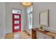 Welcoming foyer showcasing light wood floors, rustic table, and a vibrant red front door at 101 Overlake Dr, Chapel Hill, NC 27516