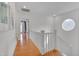 Upstairs hallway with a round window, white trim, and hardwood floors at 101 Overlake Dr, Chapel Hill, NC 27516